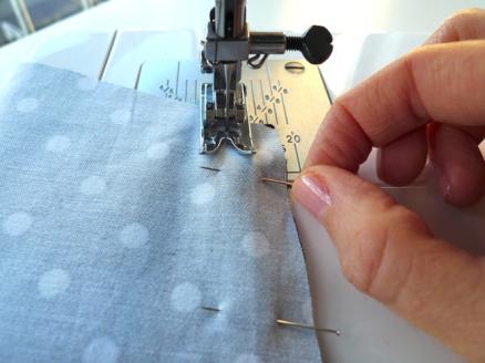 Hands at work at a sewing machine.