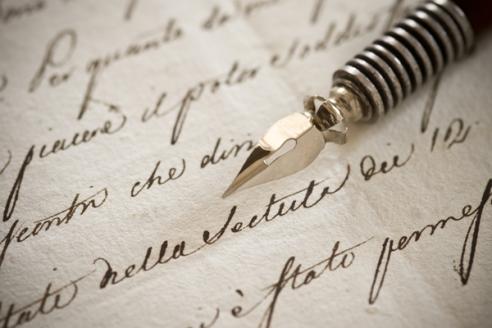 A fountain pen atop a handwritten letter.