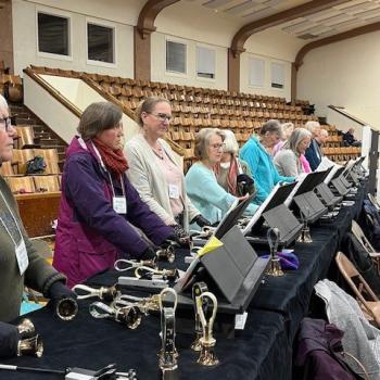 A table of bell ringers listening to their conductor. Good job ringers.