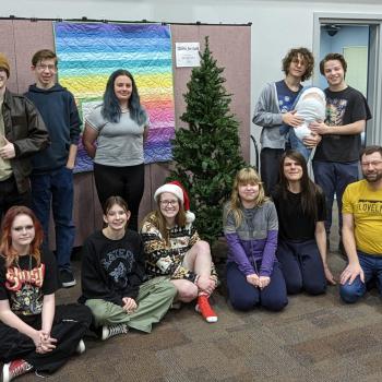 Teens gathered around the christmas tree at our 2023 christmas party.